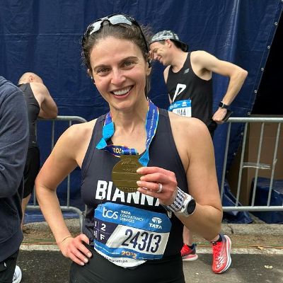 She is taking a picture with her medal.